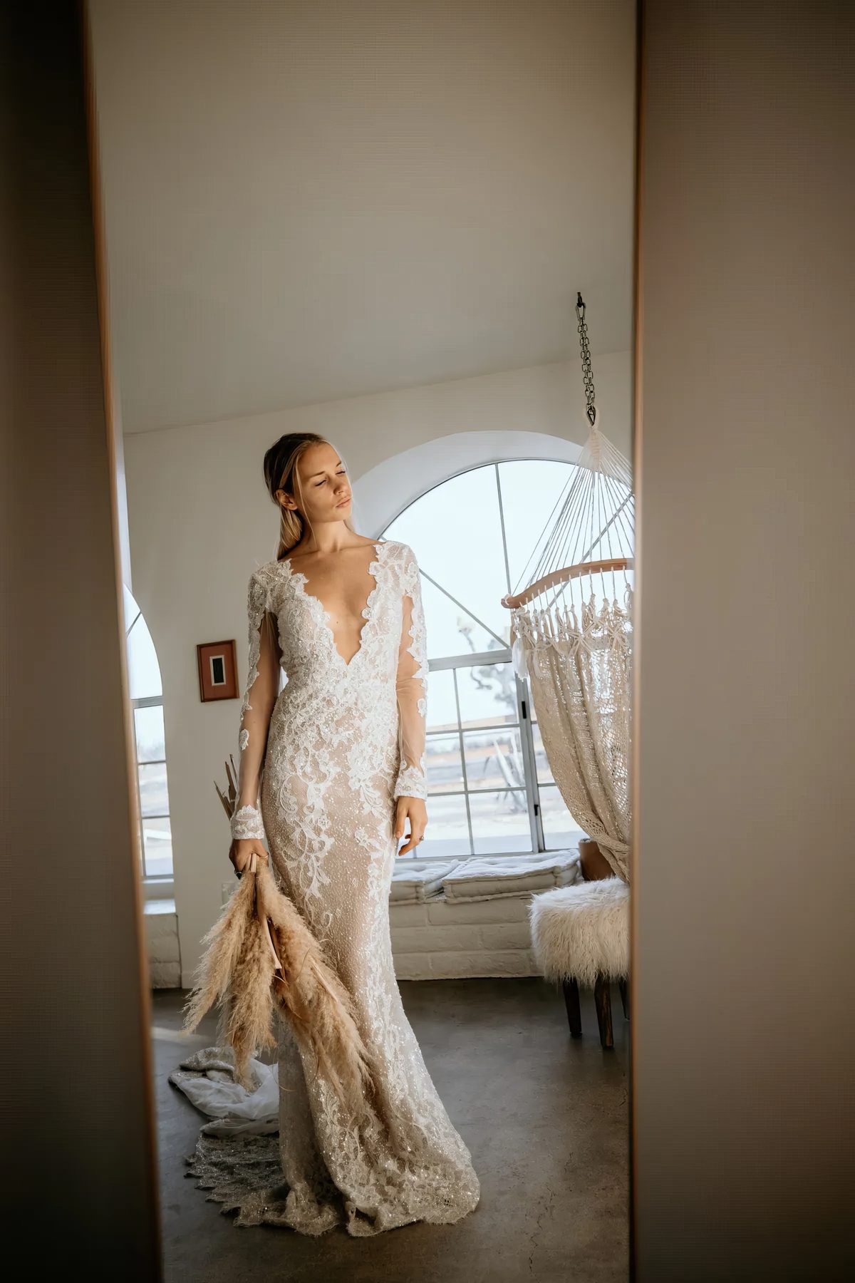A bride in the doorway of the suite at Seven Arches
